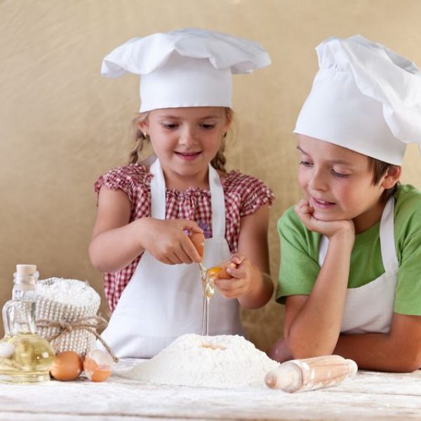 15891808 - kids with chef hats preparing tha cake dough - mixing ingredients